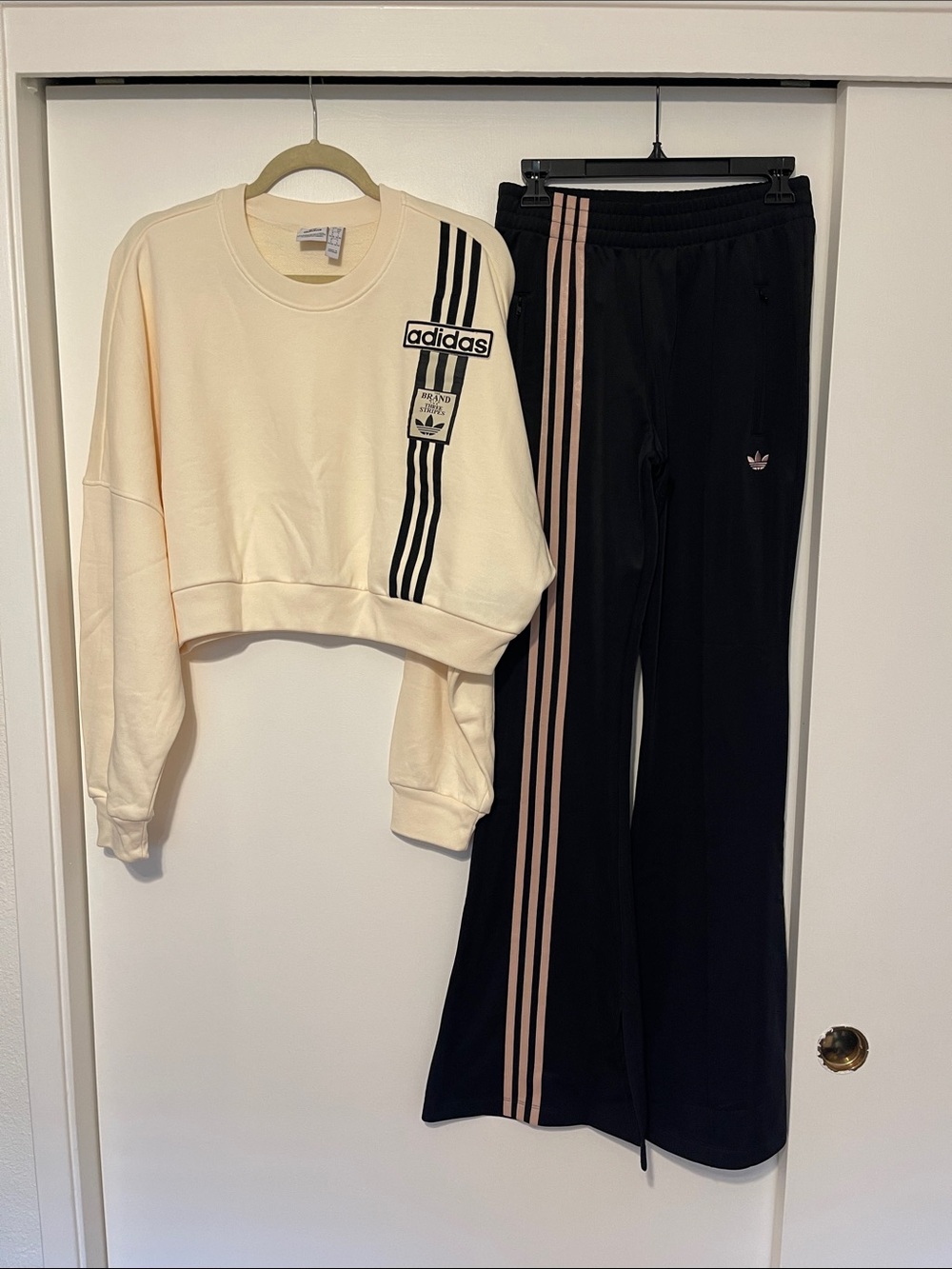 adidas Black Track Suit. Cream crop sweater. Black Pants with Pink Side Stripes
